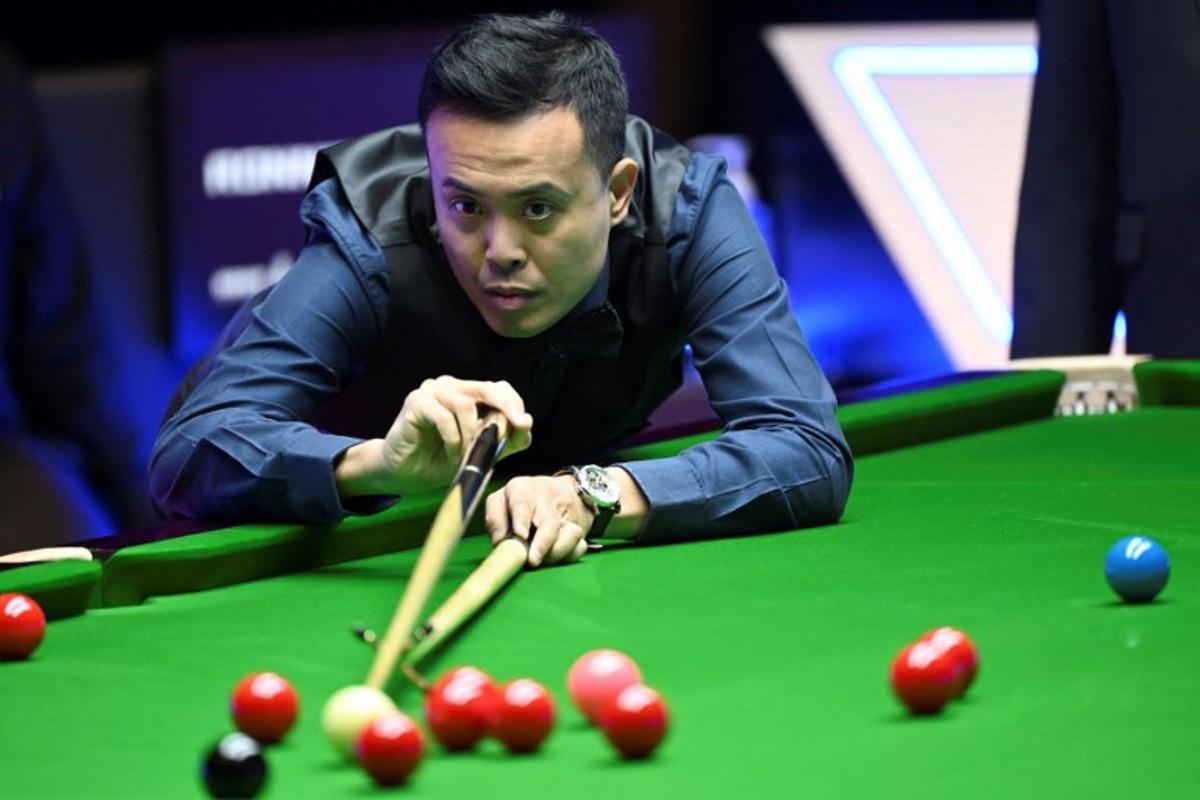 Marco Fu of Hong Kong plays a shot against Ronnie O'Sullivan of England in the final of the Hong Kong Masters snooker tournament in Hong Kong on October 9, 2022. Peter PARKS / AFP