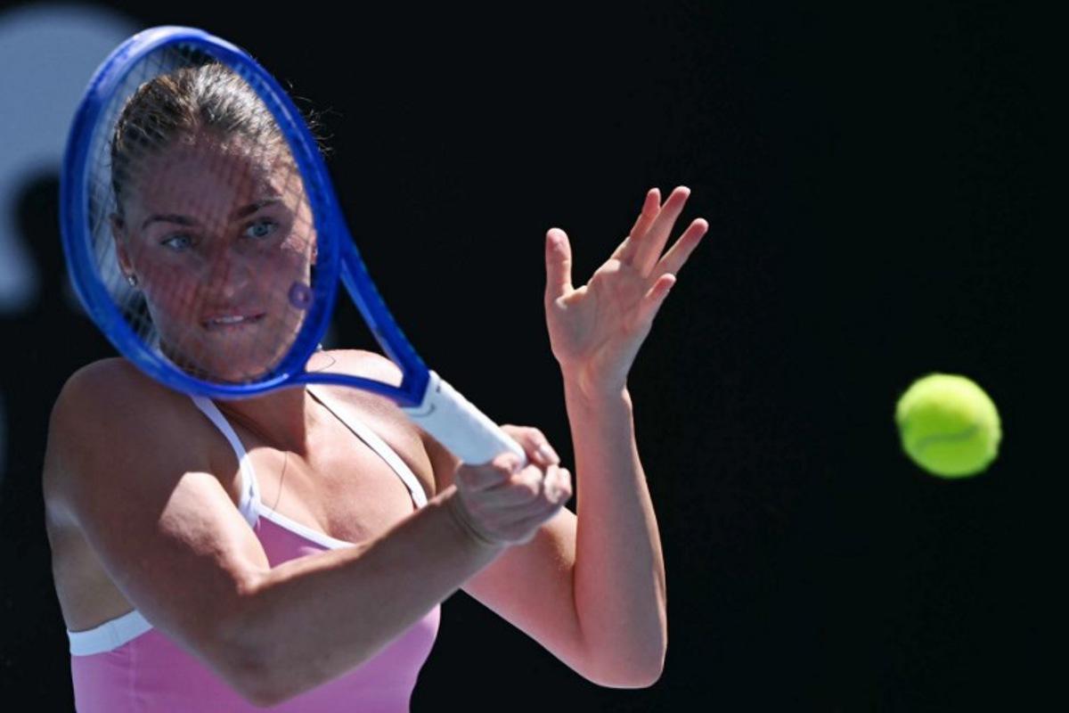 Ukraine's Marta Kostyuk hits a return against France's Elsa Jacquemot during their women's singles match on day one of the Australian Open tennis tournament in Melbourne on January 18, 2026. WILLIAM WEST / AFP