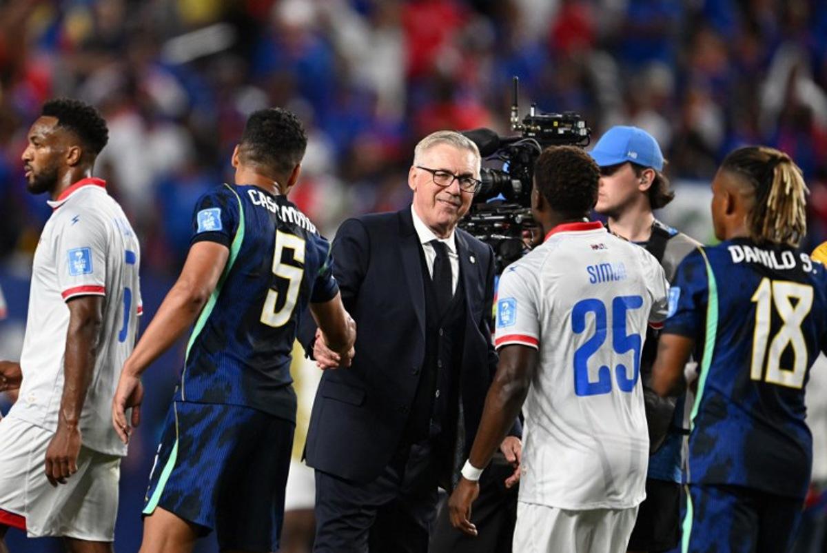 Brazil's Italian head coach Carlo Ancelotti shakes hands with midfielder #05 Casemiro past Haiti's midfielder #25 Dominique Simon after the 2026 World Cup Group C football match between Brazil and Haiti at the Philadelphia Stadium in Philadelphia on June 19, 2026. ROBERTO SCHMIDT / AFP