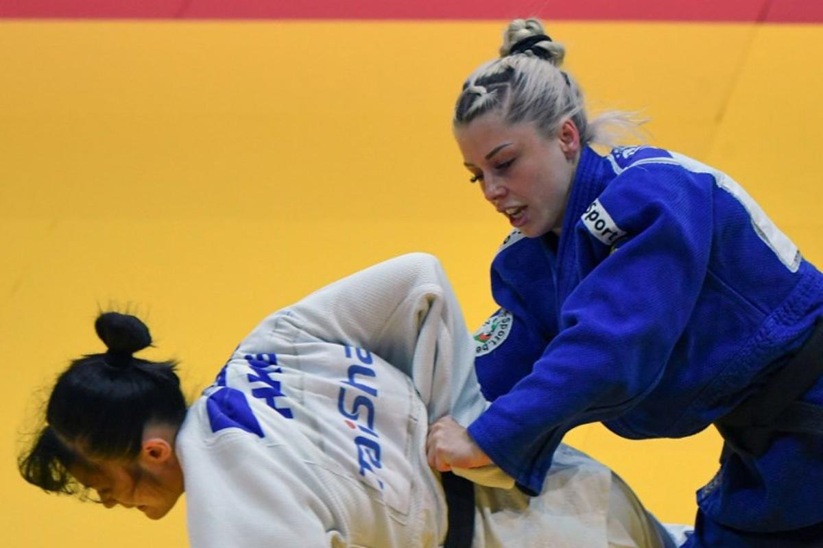 Hong Kong's Wong Ka Lee fights against Belgium's Lois Petit (blue) in the women's -48kg qualification round bout of the Judo World Championships at the Papp Laszlo Arena in Budapest, Hungary on June 13, 2025. Ferenc ISZA / AFP
