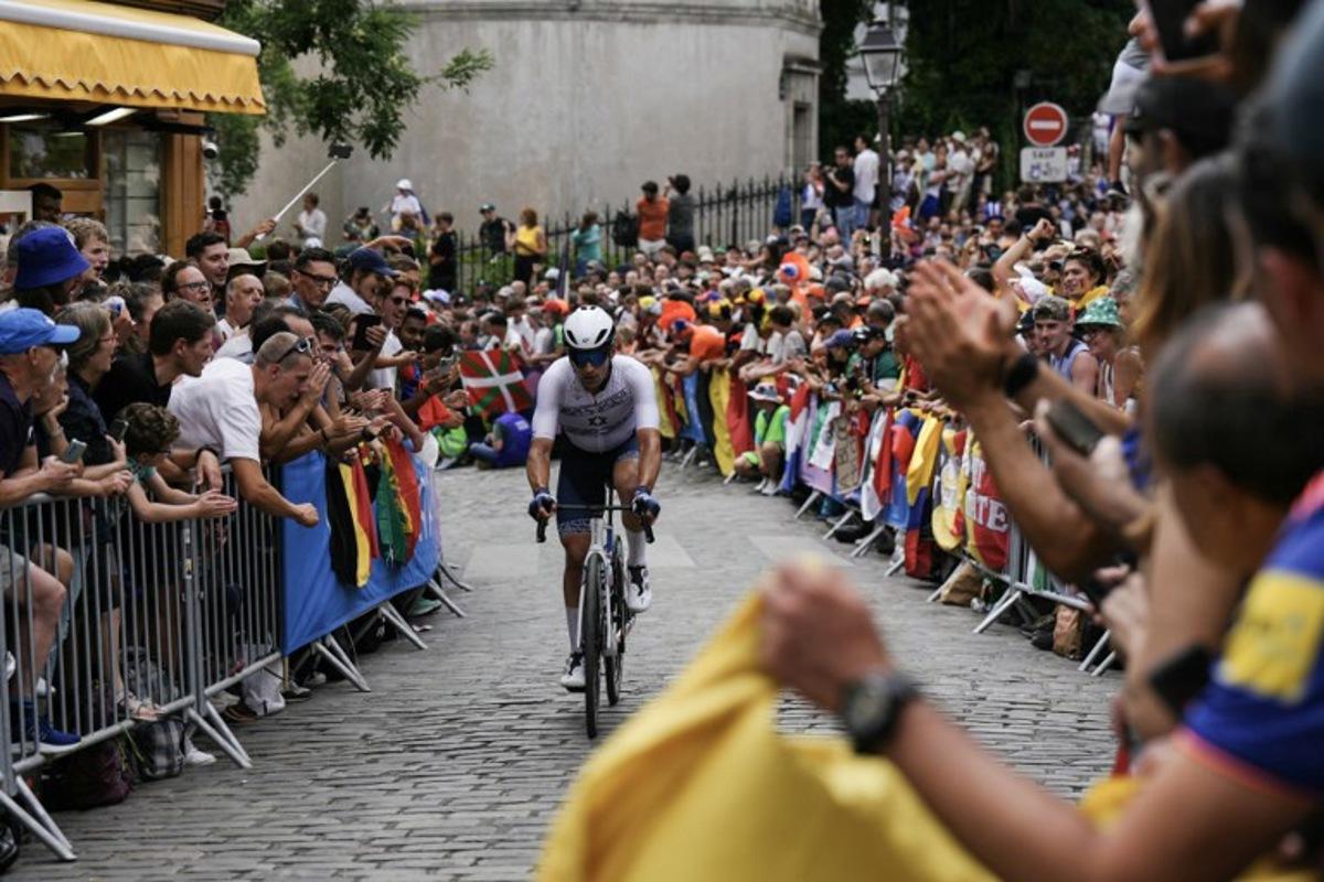 Israel's Itamar Einhorn cycles in Montmartre during the men's cycling road race during the Paris 2024 Olympic Games in Paris, on August 3, 2024. Dimitar DILKOFF / AFP