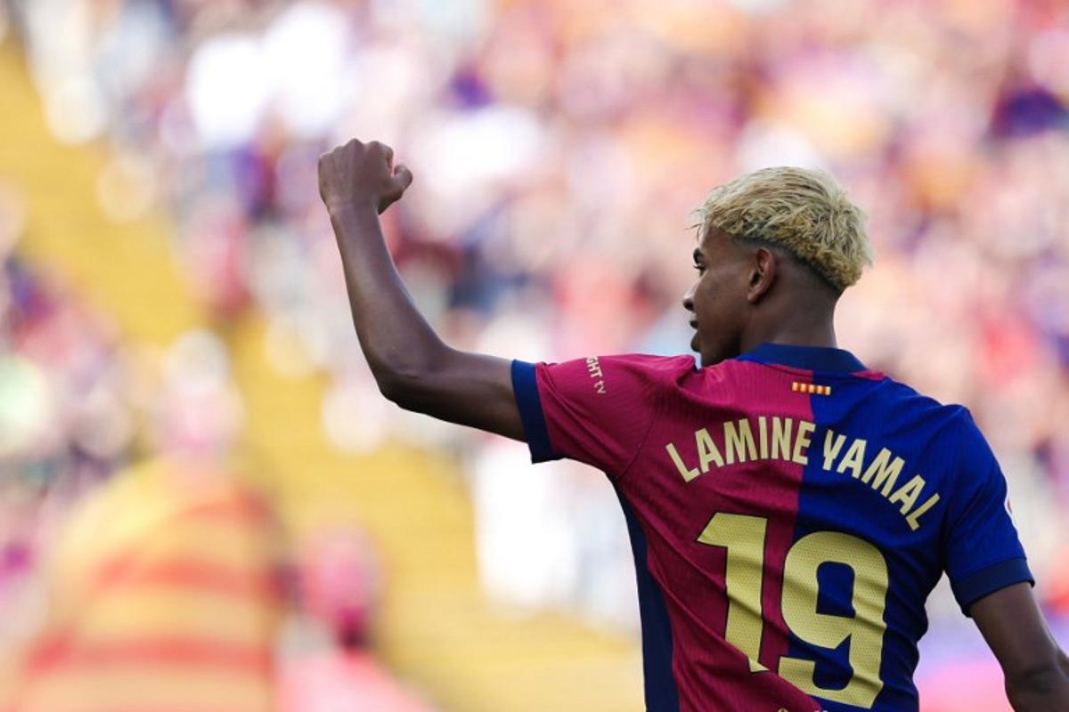Barcelona's Spanish forward #19 Lamine Yamal celebrates scoring his team's second goal during the Spanish league football match between FC Barcelona and Real Madrid CF at Estadi Olimpic Lluis Companys in Barcelona, on May 11, 2025. LLUIS GENE / AFP