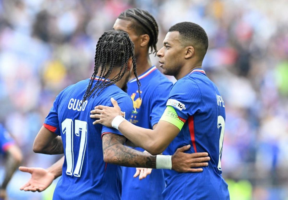 France's forward #10 Kylian Mbappe (R) celebrates scoring the opening goal with France's defender #17 Malo Gusto (L) and France's defender #04 Loic Bade during the UEFA Nations League third place play-off football match between Germany and France in Stuttgart, southwestern Germany on June 8, 2025. THOMAS KIENZLE / AFP