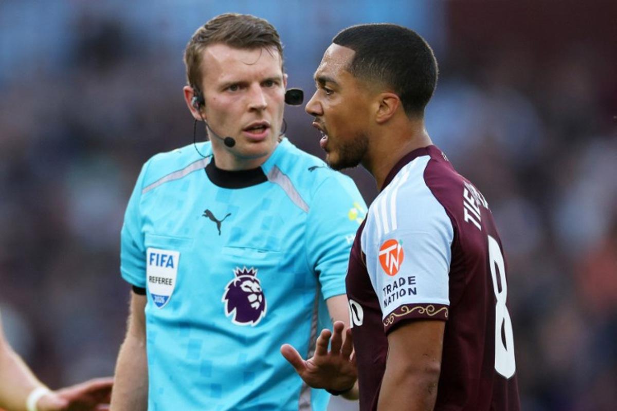 Referee Sam Barrott speaks with Aston Villa's Belgian midfielder #08 Youri Tielemans (R) during the English Premier League football match between Aston Villa and Tottenham Hotspur at Villa Park in Birmingham, central England on May 3, 2026. Adrian Dennis / AFP