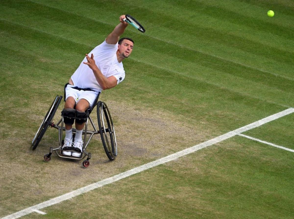 Belgium's Joachim Gerard serves against Japan's Shingo Kunieda during their men's weelchair singles semi final tennis match on the twelfth day of the 2022 Wimbledon Championships at The All England Tennis Club in Wimbledon, southwest London, on July 8, 2022. SEBASTIEN BOZON / AFP