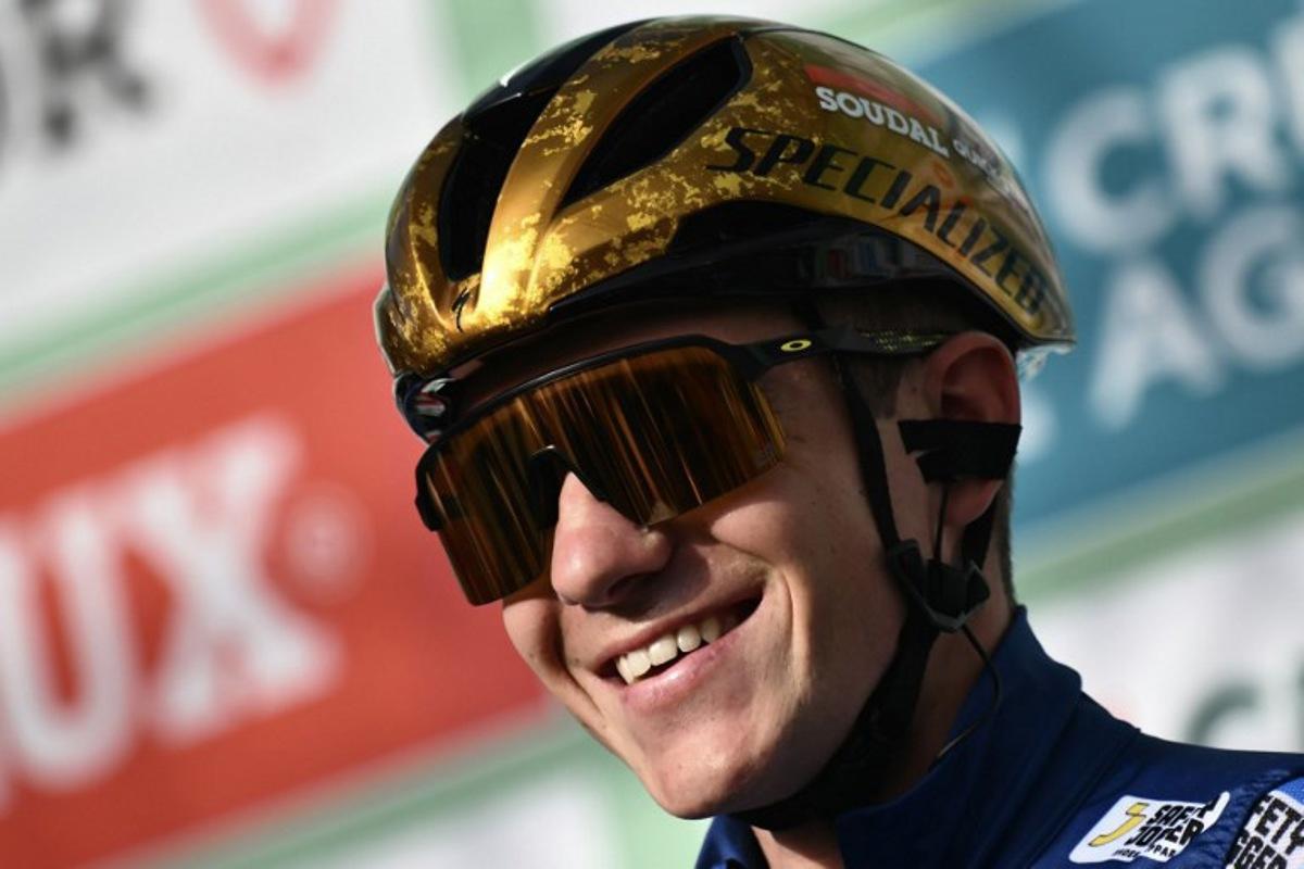 Soudal Quick-Step team's Belgian rider Remco Evenepoel looks on from the presentation podium before the start of 118th edition of the Giro di Lombardia (Tour of Lombardy), a 252km cycling race from Bergamo to Como on October 12, 2024. Marco BERTORELLO / AFP