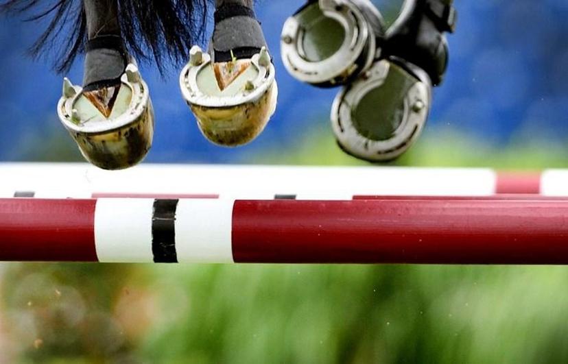 The hooves of a horse are seen as a show jumper overcomes an obstacle during the CHIO equestrian event in Aachen, western Germany, on July 15, 2014. The World Equestrian Festival including jumping, dressage, eventing, vaulting and driving events is running from July 11 to 20, 2014. UWE ANSPACH / DPA / AFP GERMANY OUT