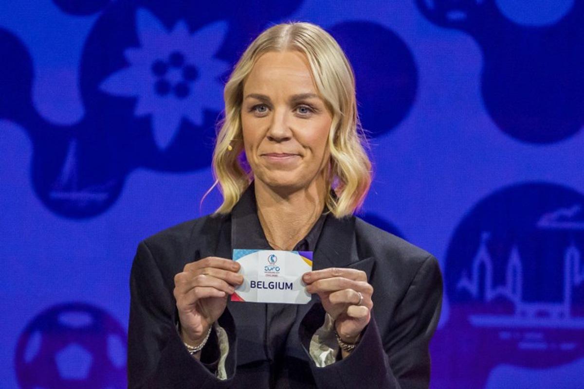 Former Swiss football player Caroline Seger shows the paper slip of Belgium during the draw for UEFA Women's Euro 2025 in Lausanne, on December 16, 2024. Fabrice COFFRINI / AFP