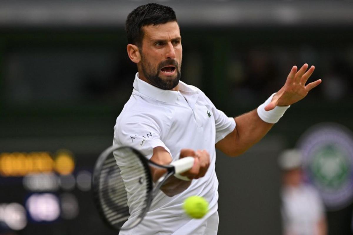 Serbia's Novak Djokovic plays a forehand return to Serbia's Miomir Kecmanovic during their men's singles third round tennis match on the sixth day of the 2025 Wimbledon Championships at The All England Lawn Tennis and Croquet Club in Wimbledon, southwest London, on July 5, 2025. Glyn KIRK / AFP