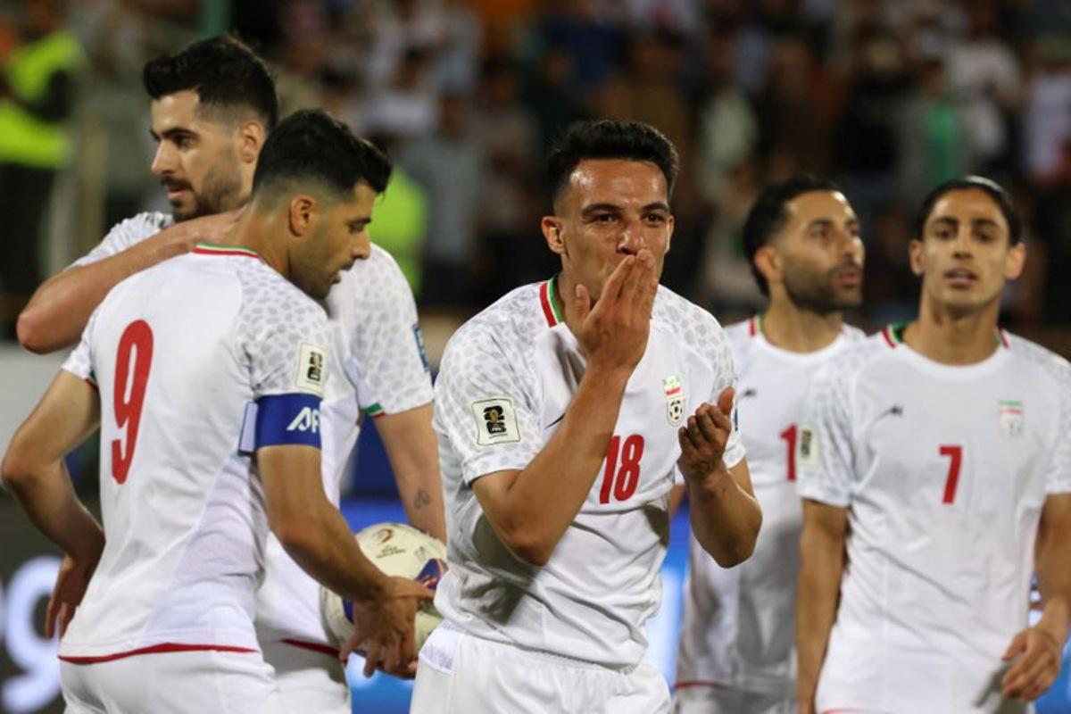 Iran's midfielder #18 Amirhossein Hosseinzadeh celebrates scoring his team's third goal during the FIFA World Cup 2026 Asia zone qualifiers group A football match between Iran and the North Korea at the Azadi Sports Complex in Tehran on June 10, 2025. ATTA KENARE / AFP