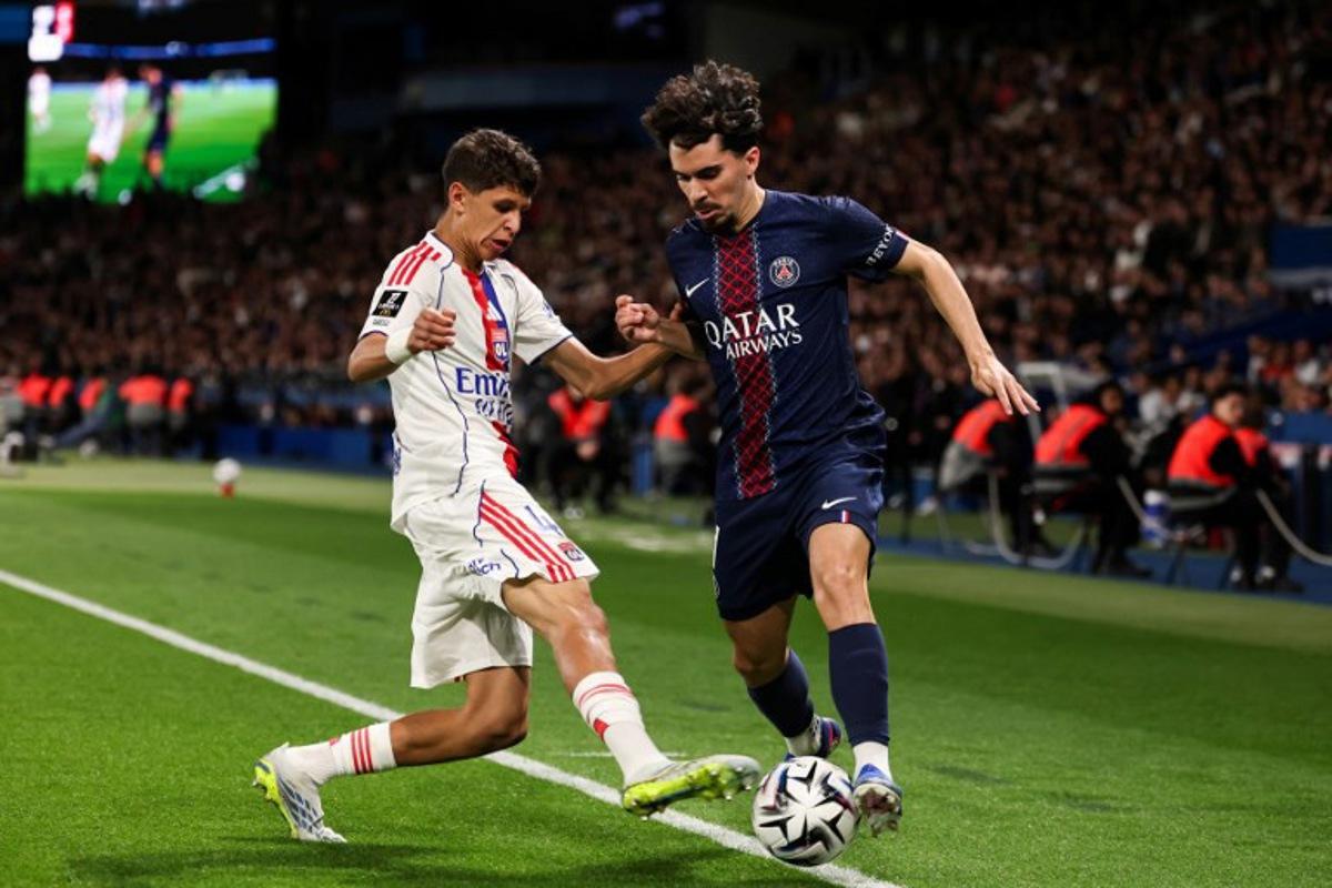 Lyon's French midfielder #44 Khalis Merah (L) fights for the ball with Paris Saint-Germain's Portuguese midfielder #17 Vitinha (R) during the French L1 football match between Paris Saint-Germain (PSG) and Olympique Lyonnais (OL) at the Parc des Princes stadium in Paris on April 19, 2026. FRANCK FIFE / AFP