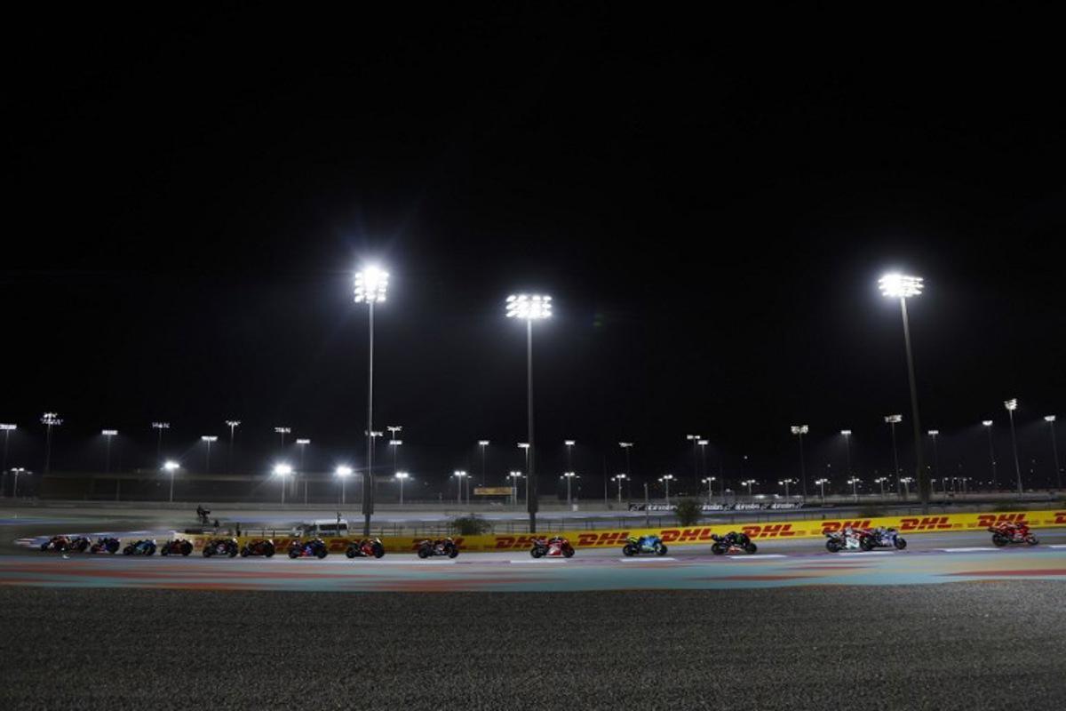 Riders compete during the Qatar MotoGP Grand Prix at the Lusail International Circuit in Lusail, north of Doha, on April 13, 2025. Karim JAAFAR / AFP