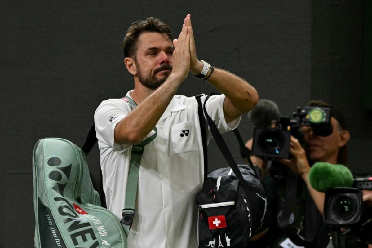 Switzerland's Stan Wawrinka gestures to the crowd as he leaves following his defeat to Italy's Matteo Berrettini during their men's singles first round tennis match on the second day of the 2026 Wimbledon Championships at The All England Lawn Tennis and Croquet Club in Wimbledon, southwest London, on June 30, 2026. Glyn KIRK / AFP