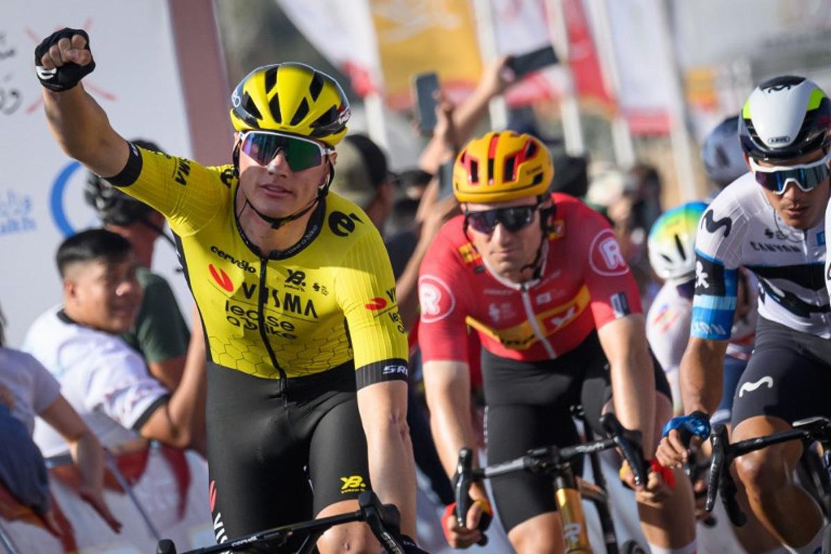 Visma-Lease a Bike team's Belgian rider Olav Kooij (L) celebrates while crossing the finish line to win the fourth stage of the Tour of Oman cycling race from Oman Across Ages Museum to Oman Convention Center, on February 11, 2025. Loic VENANCE / AFP