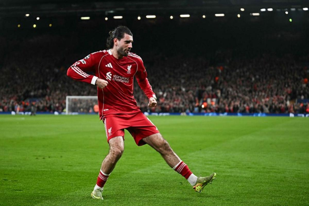 Liverpool's Hungarian midfielder #08 Dominik Szoboszlai celebrates scoring his team's first goal during the UEFA Champions League, round of 16 second leg football match between Liverpool and Galatasaray at Anfield in Liverpool, north-west England on March 18, 2026. Paul ELLIS / AFP