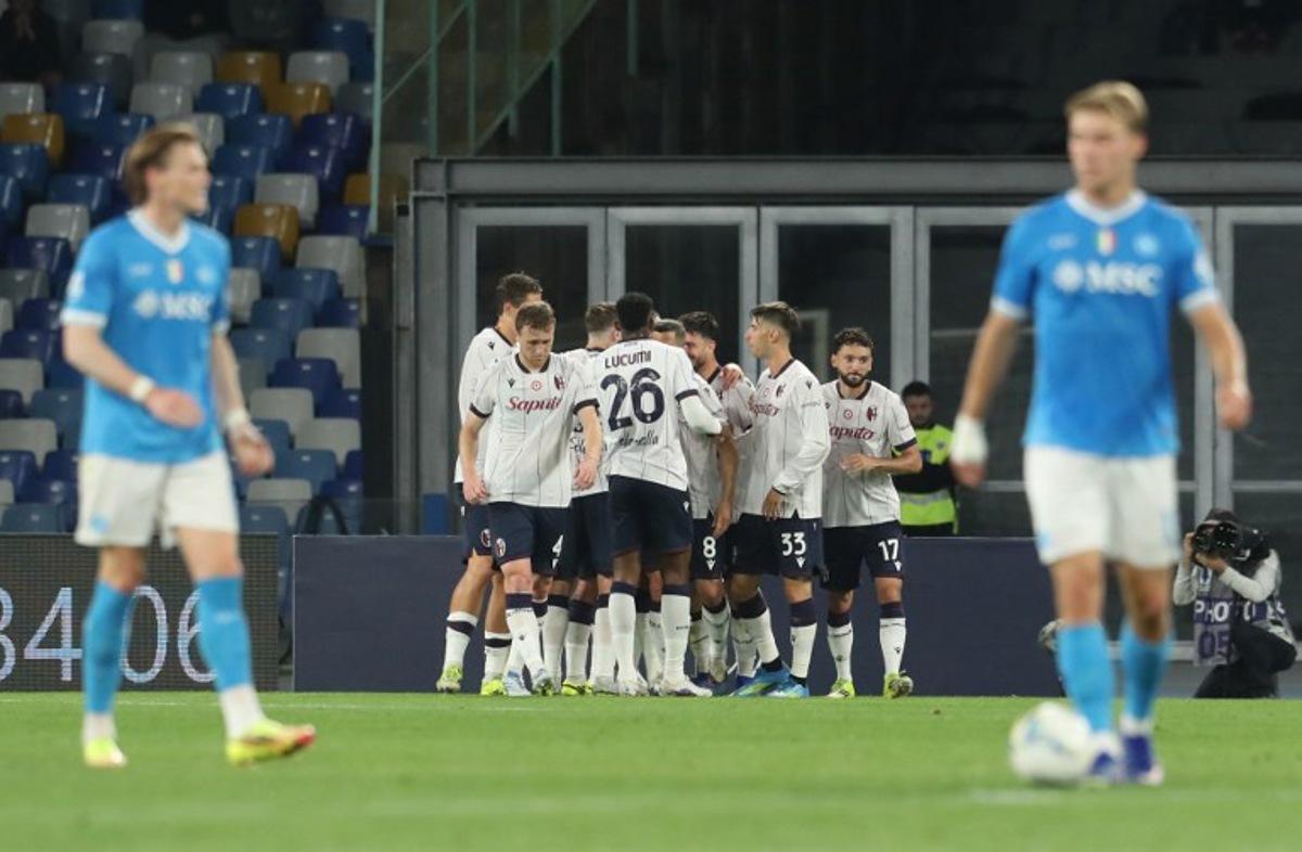 Bologna's Italian forward #7 Riccardo Orsolini (hidden) celebrates with teammates after scoring a goal on penalty during the Italian Serie A football match between SSC Napoli and Bologna FC 1909 at the Diego Armando Maradona Stadium in Naples on May 11, 2026. CARLO HERMANN / AFP