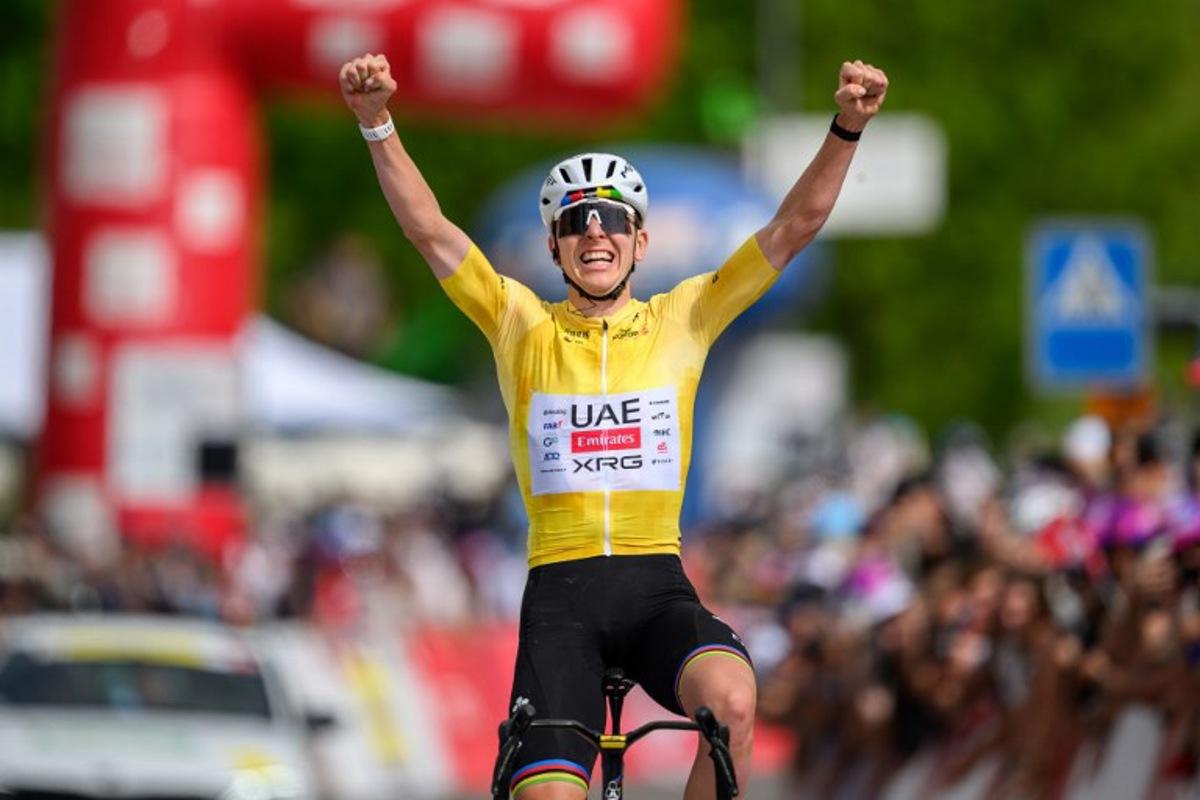 UAE Team Emirates-XRG's Slovenian rider Tadej Pogacar celebrates as he crosses the finish line wining the fourth stage of the Tour of Romandie UCI cycling World tour, 149.6 km from Broc and to Charmey, in Charmey, Switzerland, on May, 2, 2026. Fabrice COFFRINI / AFP