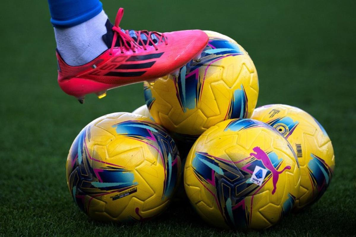 (FILES) The winter edition of the Series A official balls are pictured before the Italian Serie A football match Torino vs Napoli at the "Stadio Grande Torino" in Turin on December 1, 2024. The last four matches of the 33rd day of the Italian football championship, scheduled on April 21, 2025, have been postponed on April 23, 2025 after the death of Pope Francis. MARCO BERTORELLO / AFP