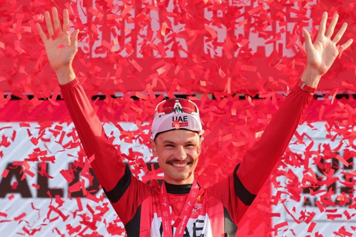 UAE Team Emirates' Australian cyclist Jay Vine celebrates being the leader of the race on the podium following stage 6 of the 6th UAE Cycling Tour from the Louvre Abu Dhabi to Abu Dhabi Breakwater on February 24, 2024. Giuseppe CACACE / AFP