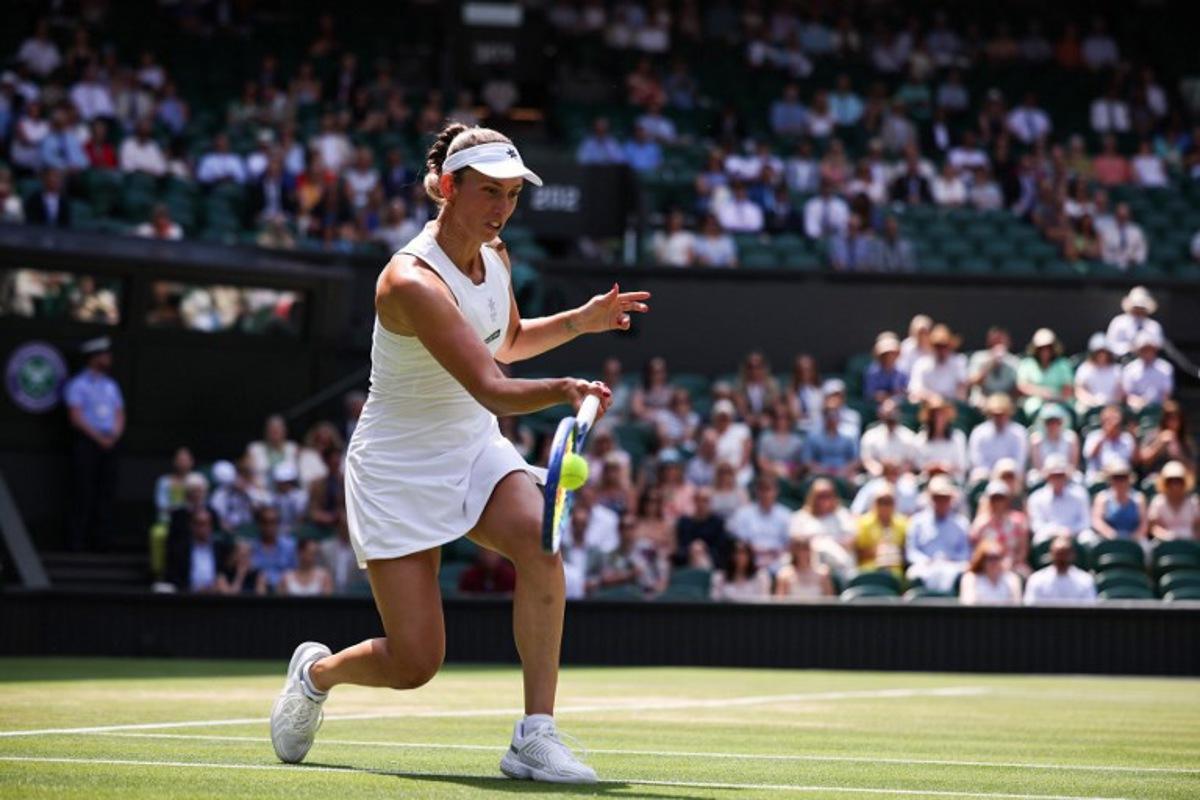 Belgium's Elise Mertens playing with Russia's Veronika Kudermetova returns the ball to Taiwan's Hsieh Su-wei and Latvia's Jelena Ostapenko during their women's doubles final tennis match on the fourteenth day of the 2025 Wimbledon Championships at The All England Lawn Tennis and Croquet Club in Wimbledon, southwest London, on July 13, 2025. HENRY NICHOLLS / AFP