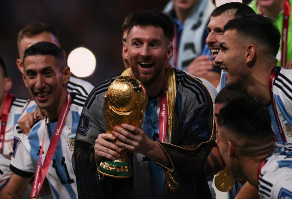 Argentina's captain and forward #10 Lionel Messi lifts the FIFA World Cup Trophy during the trophy ceremony after Argentina won the Qatar 2022 World Cup final football match between Argentina and France at Lusail Stadium in Lusail, north of Doha on December 18, 2022. Adrian DENNIS / AFP