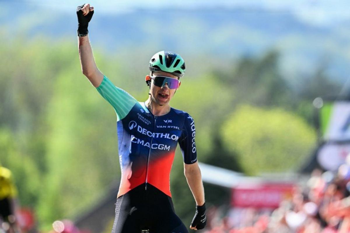 Decathlon CMA CGM Team's French Paul Seixas celebrates as he crosses the finish line to win 'La Fleche Wallonne' one day cycling race, 200 km from Herstal to Huy, on April 22, 2026. JOHN THYS / AFP