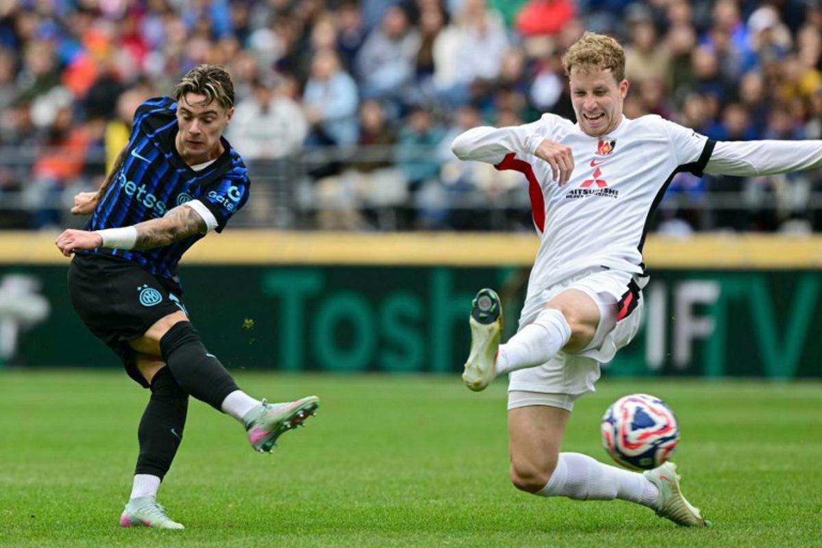 Inter Milan's Polish midfielder #59 Nicola Zalewski (L) shoots but fails to score next to Urawa Red Diamonds' Swedish midfielder #11 Samuel Gustafson during the FIFA Club World Cup 2025 Group E football match between Italy's Inter Milan and Japan's Urawa Red Diamonds at the Lumen Field stadium in Seattle on June 21, 2025. Pablo PORCIUNCULA / AFP