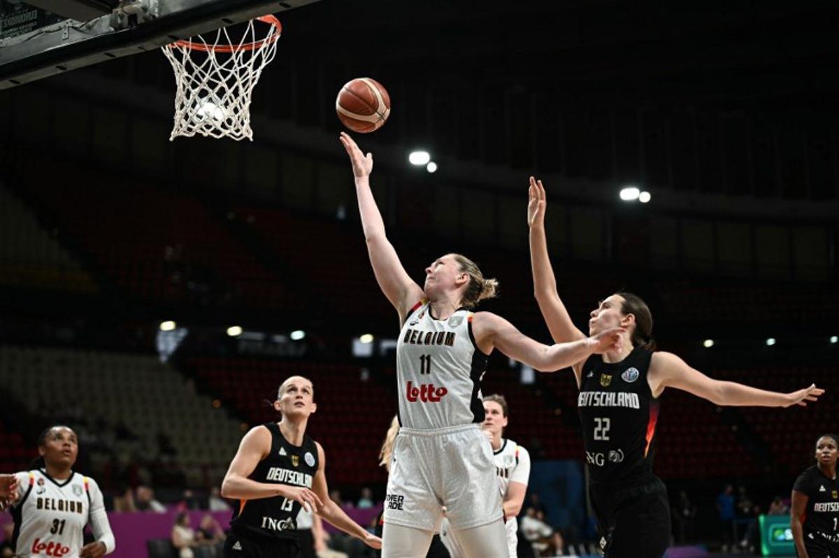 Belgium's power forward Emma Meesseman (C) attempts a lay-up as she is defended by Germany's small forward Emily Bessoir (R) during the FIBA Women's EuroBasket 2025 quarter-final match between Belgium and Germany at the Peace and Friendship Stadium in Piraeus near Athens on June 25, 2025. Angelos Tzortzinis / AFP