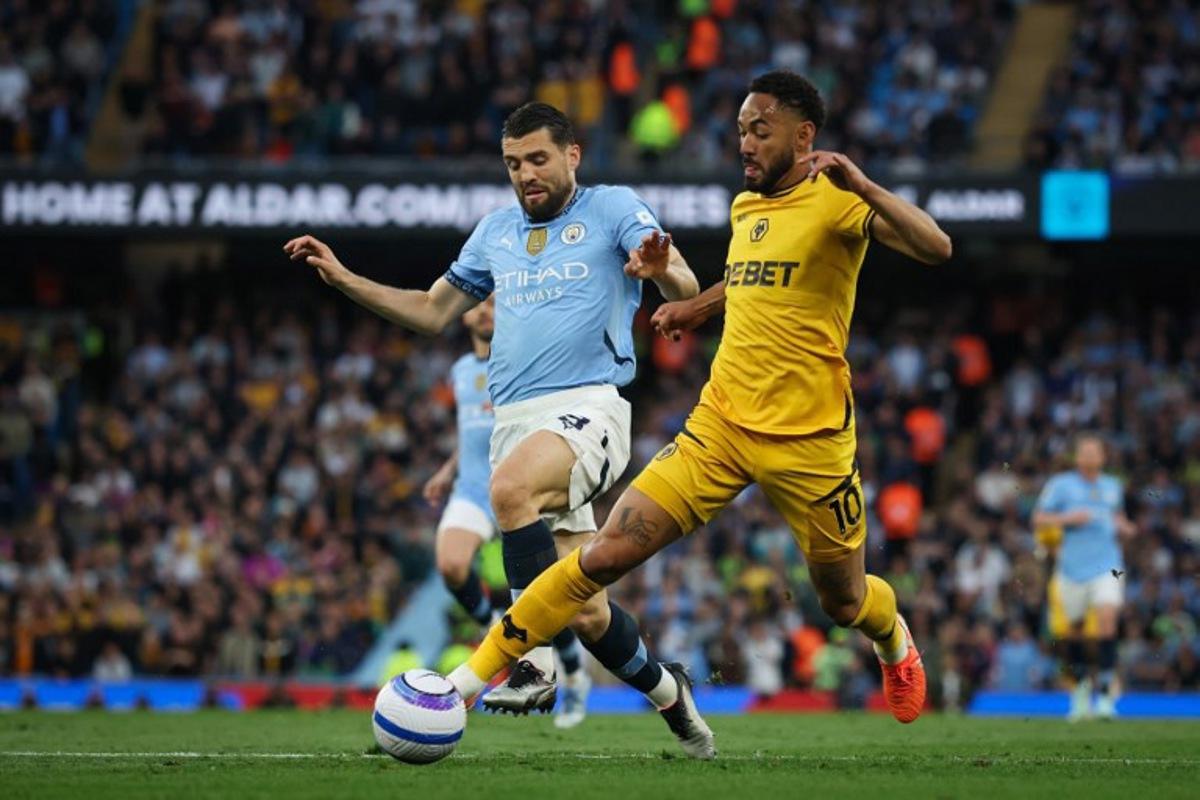 Manchester City's Croatian midfielder #08 Mateo Kovacic (L) fights for the ball with Wolverhampton Wanderers' Brazilian striker #10 Matheus Cunha (R) during the English Premier League football match between Manchester City and Wolverhampton Wanderers at the Etihad Stadium in Manchester, north west England, on May 2, 2025. Darren Staples / AFP