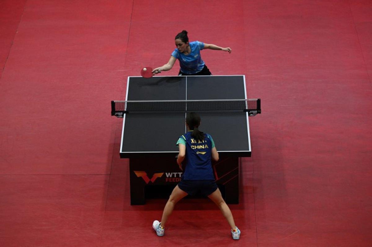 Argentina's Ana Codina (Top) hits a return to China's Xu Jaiyi during their women's singles final table teennis match of the World Table Tennis (WTT) Feeder Series at Popper & Lopez Sports Center in Caracas on November 3, 2024. Federico PARRA / AFP
