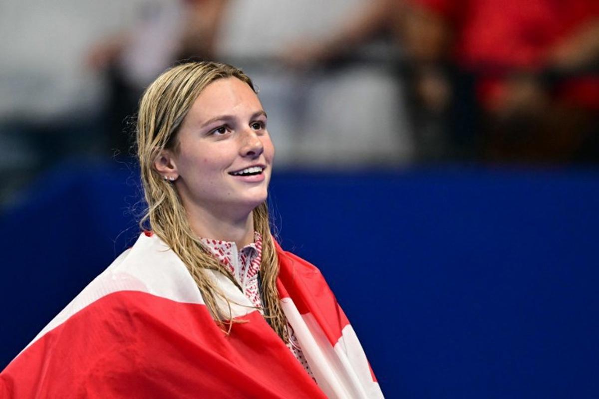 Gold medallist Canada's Summer Mcintosh celebrates during the podium ceremony of the women's 200m individual medley swimming event during the Paris 2024 Olympic Games at the Paris La Defense Arena in Nanterre, west of Paris, on August 3, 2024. Manan VATSYAYANA / AFP