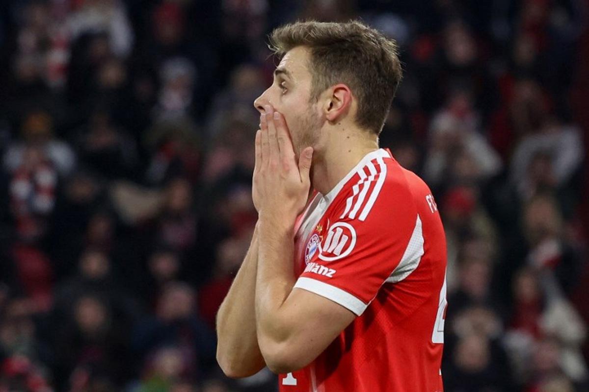 Bayern Munich's Croatian defender #44 Josip Stanisic reacts after a miss during the German first division Bundesliga football match between FC Bayern Munich and Mainz 05 in Munich, southern Germany on December 14, 2025. Karl-Josef HILDENBRAND / AFP