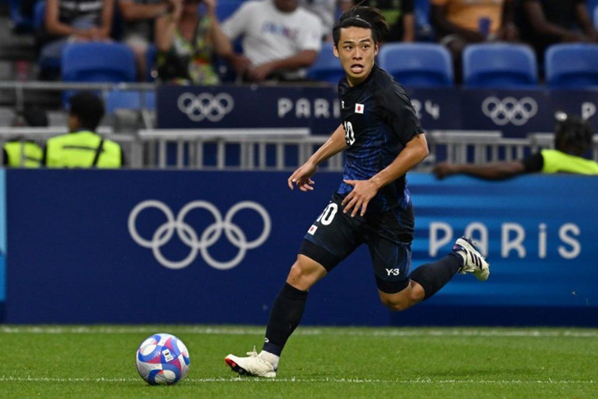 Japan's forward #10 Koki Saito runs with the ball in the men's quarter-final football match between Japan and Spain during the Paris 2024 Olympic Games at the Lyon Stadium in Lyon on August 2, 2024. Arnaud FINISTRE / AFP