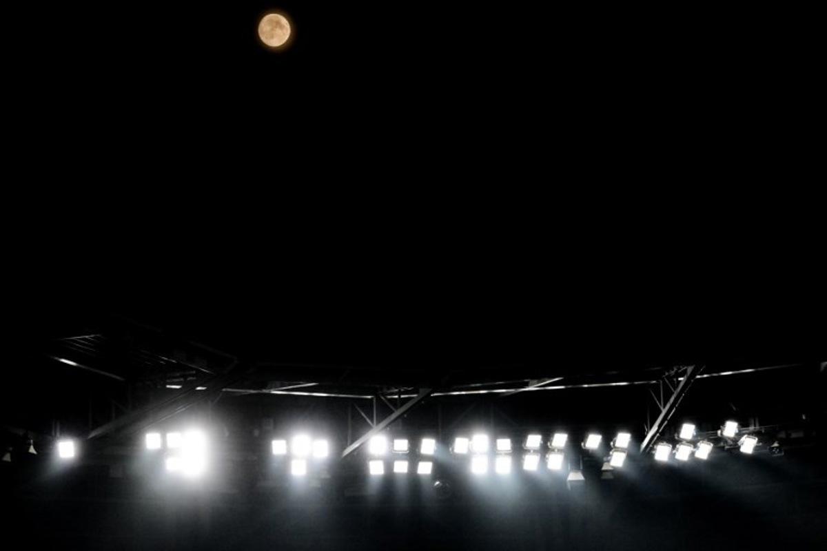 This photograph shows a view of the full moon during the UEFA Champions League qualifying playoff - second leg football match between Olympique Lyonnais (OL) and Fenerbahce SK over the Groupama Stadium in Decines-Charpieu, central-eastern France, on August 26, 2026. OLIVIER CHASSIGNOLE / AFP
