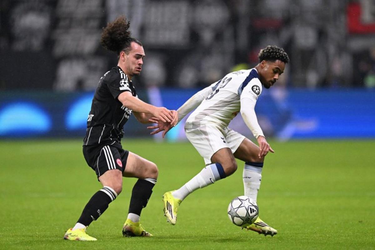 Frankfurt's Belgian defender #03 Arthur Theate and Tottenham Hotspur's French midfielder #28 Wilson Odobert vie for the ball during the UEFA Champions League league phase- day 8 football match between Eintracht Frankfurt and Tottenham Hotspur in Frankfurt, western Germany, on January 28, 2026. Kirill KUDRYAVTSEV / AFP