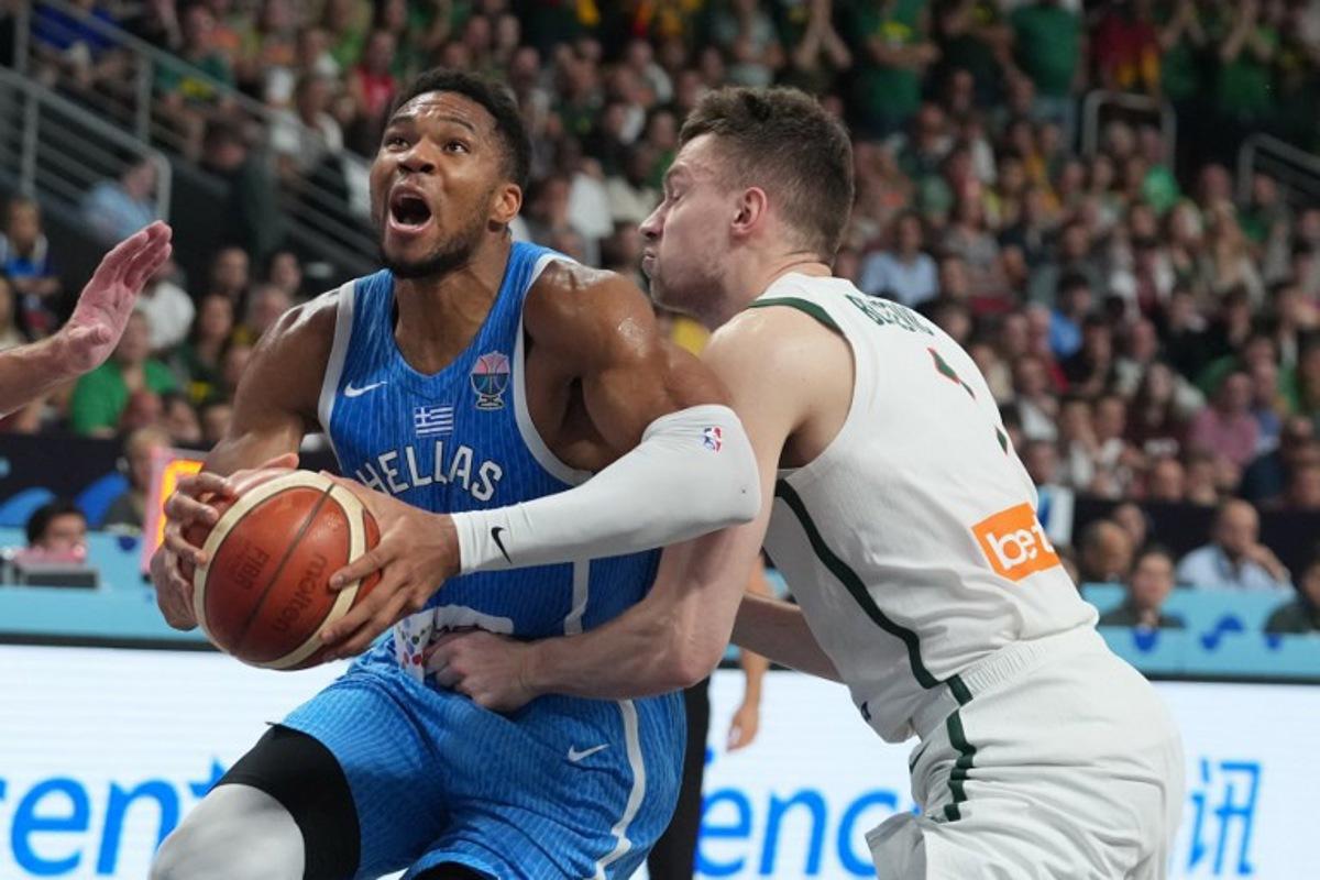Greece's small forward #34 Giannis Antetokounmpo (L) vies with Lithuania's center #01 Marek Blazevic during the FIBA EuroBasket 2025 basketball quarter final match between Lithuania and Greece at the Arena Riga in Riga, Latvia, on September 9, 2025. Gints Ivuskans / AFP