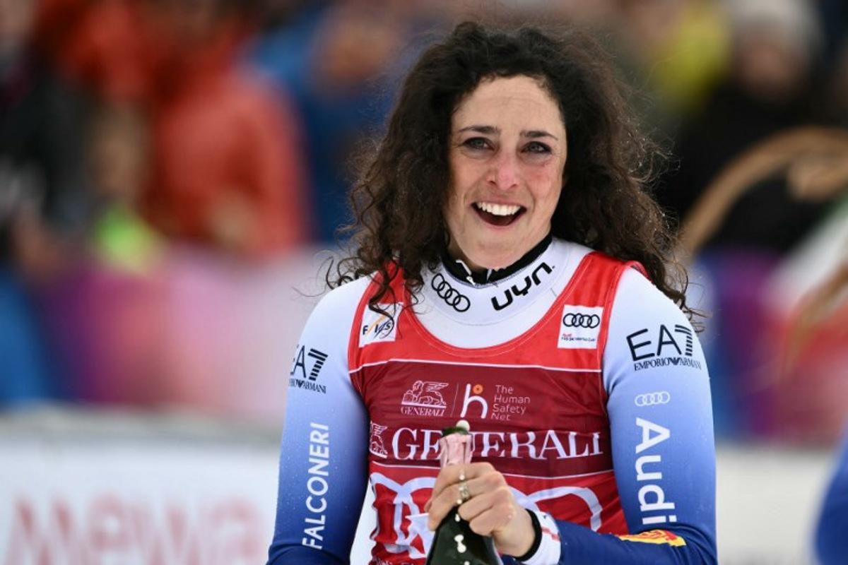 Italy's Federica Brignone celebrates on the podium of the Women's Super G replacing St Moritz event of FIS Alpine Skiing World Cup in La Thuile, Italy on March 14, 2025. Italy's Federica Brignone won the race ahead of Italy's Sofia Goggia and France's Romane Miradoli, third. A sensational run from Brignone gave her victory in the Italian alps by just 0.01sec over her compatriot Sofia Goggia. It extended her lead in the overall standings on Lara Gut-Behrami to 382 points. Marco BERTORELLO / AFP