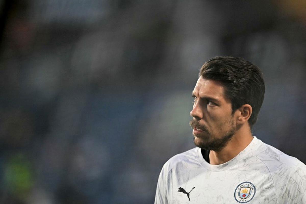 Manchester City's German goalkeeper #18 Stefan Ortega looks on during the warmup ahead of the FIFA Club World Cup 2025 round of 16 football match between England's Manchester City and Saudi's Al-Hilal at the Camping World stadium in Orlando on June 30, 2025. PATRICIA DE MELO MOREIRA / AFP