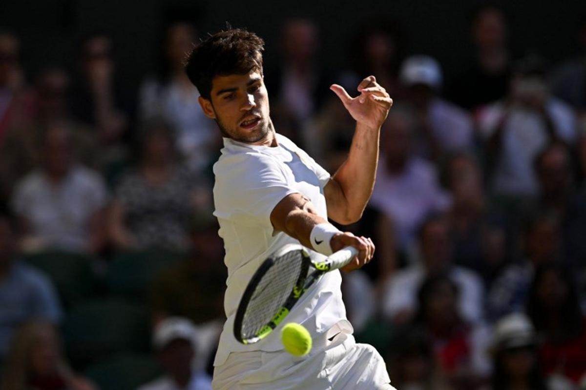Spain's Carlos Alcaraz plays a forehand return to Britain's Cameron Norrie during their men's singles quarter-final tennis match on the ninth day of the 2025 Wimbledon Championships at The All England Lawn Tennis and Croquet Club in Wimbledon, southwest London, on July 8, 2025. Glyn KIRK / AFP