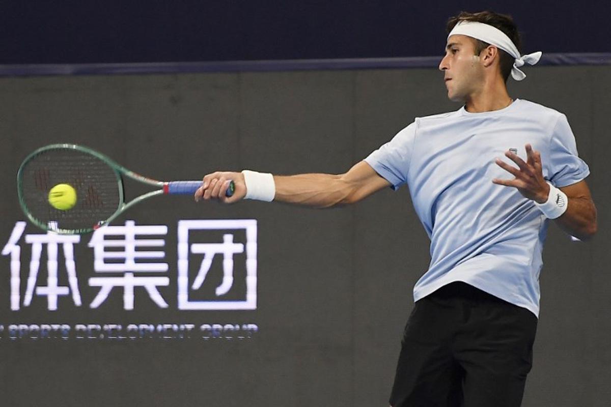 Argentina's Tomas Martin Etcheverry hits a return to France's Corentin Moutet during their men's singles quarter-final match at the Hangzhou Open tennis tournament in Hangzhou, in China's eastern Zhejiang province on September 21, 2025. STR / AFP