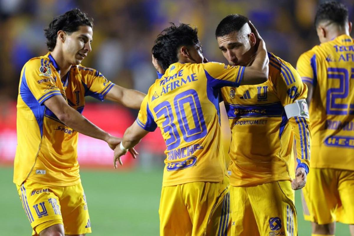 Tigres' forward #30 Diego Sanchez celebrates with Uruguayan midfielder #08 Fernando Gorriaran (R) and midfielder #16 Diego Lainez after scoring his team's third goal during the Mexican League Clausura Tournament quarterfinal first leg football match between Tigres and Guadalajara at the Universitario stadium in Monterrey, Nuevo Leon state, Mexico on May 2, 2026. Julio Cesar AGUILAR / AFP
