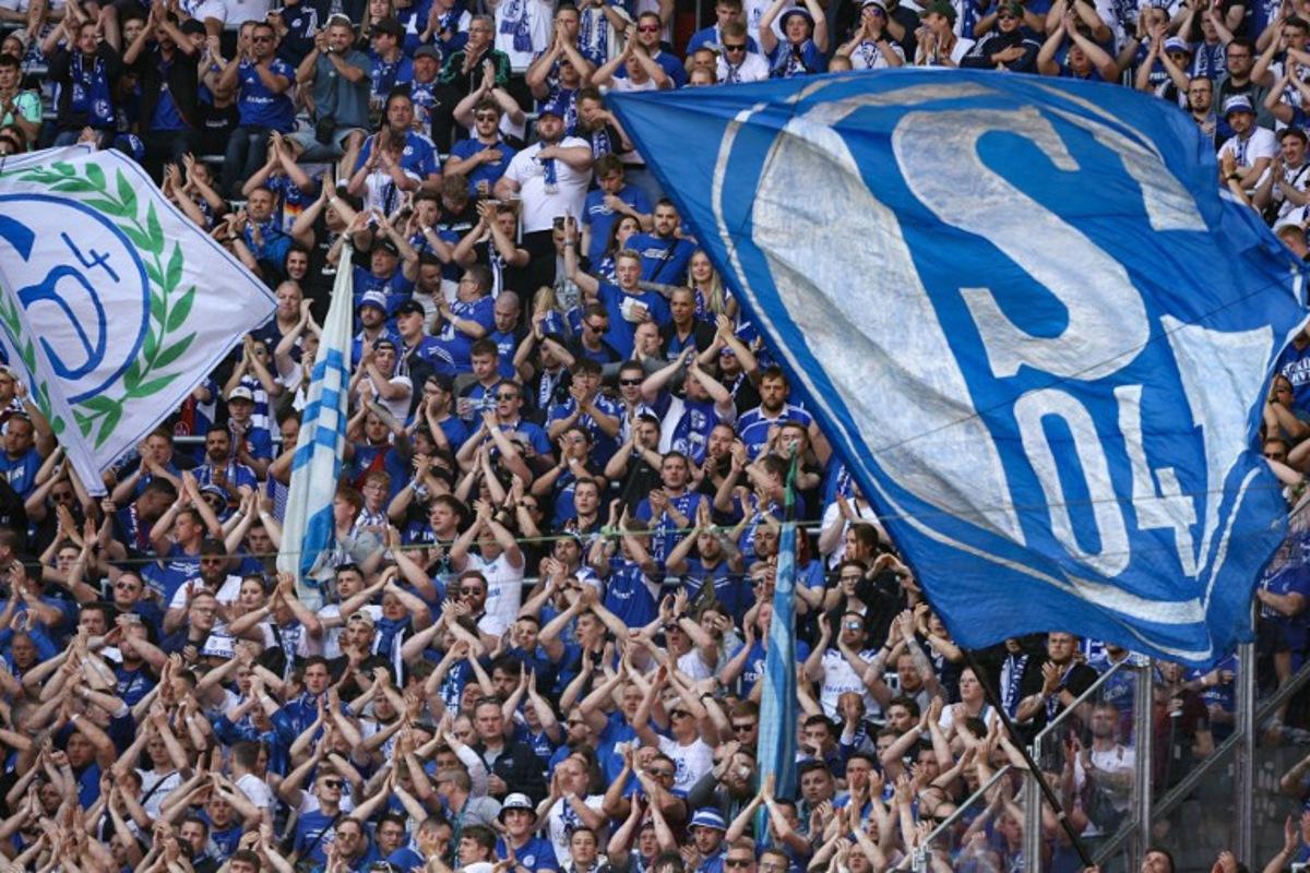 Schalke 04 football fans cheer on their team during the German first division Bundesliga football match between RB Leipzig and FC Schalke 04 in Leipzig, eastern Germany on May 27, 2023. Ronny HARTMANN / AFP