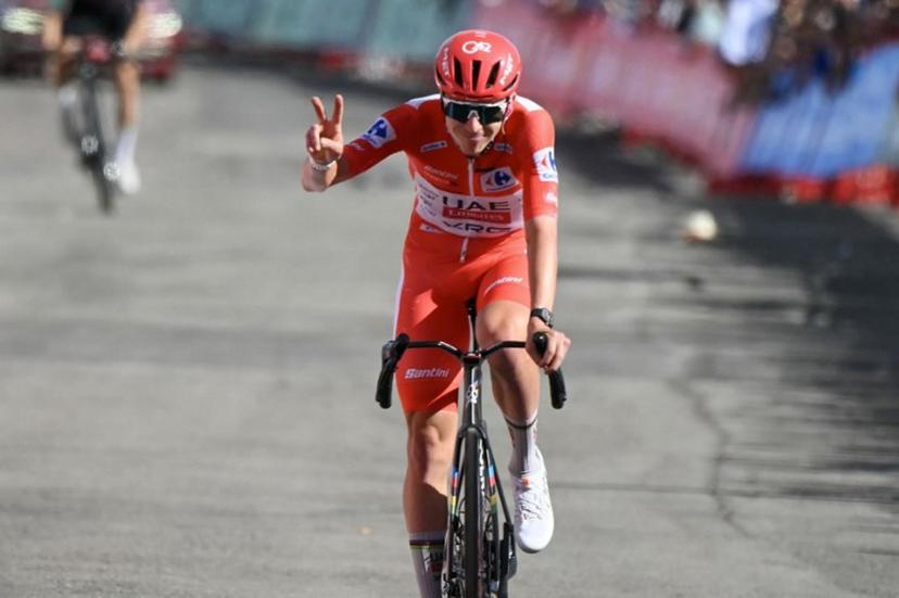 Overall race leader, UAE Team Emirates - XRG team's Slovenian rider Tadej Pogacar, gestures as he crosses the finish line of the seventh stage of the Vuelta a Espana 2026, a 149,8 km race between Vall d'Alba and Aramon Valdelinares on August 28, 2026. JOSE JORDAN / AFP