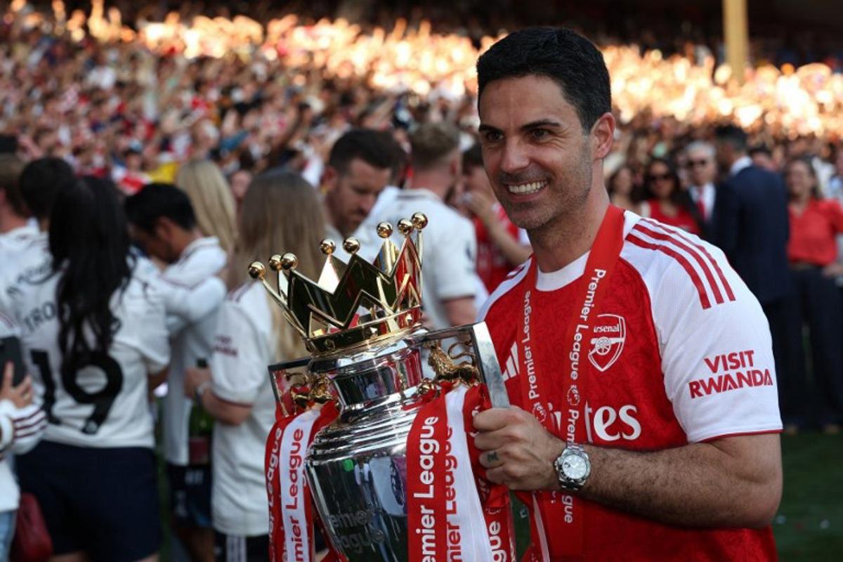 Arsenal's Spanish manager Mikel Arteta poses with the Premier League trophy at a presentation ceremony on the pitch after the English Premier League football match between Crystal Palace and Arsenal at Selhurst Park in south London on May 24, 2026. Arsenal are English league champions for the first time since 2004, winning the league by seven points. Adrian Dennis / AFP