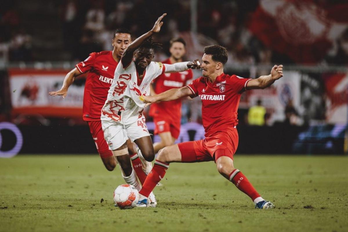 Salzburg's Dorgeles Nene and FC Twente's Alec Van Hoorenbeeck vie for the ball during the UEFA Champions League qualification football match between Salzburg and Twente in Salzburg, on August 6, 2024. EXPA / JFK / APA / AFP