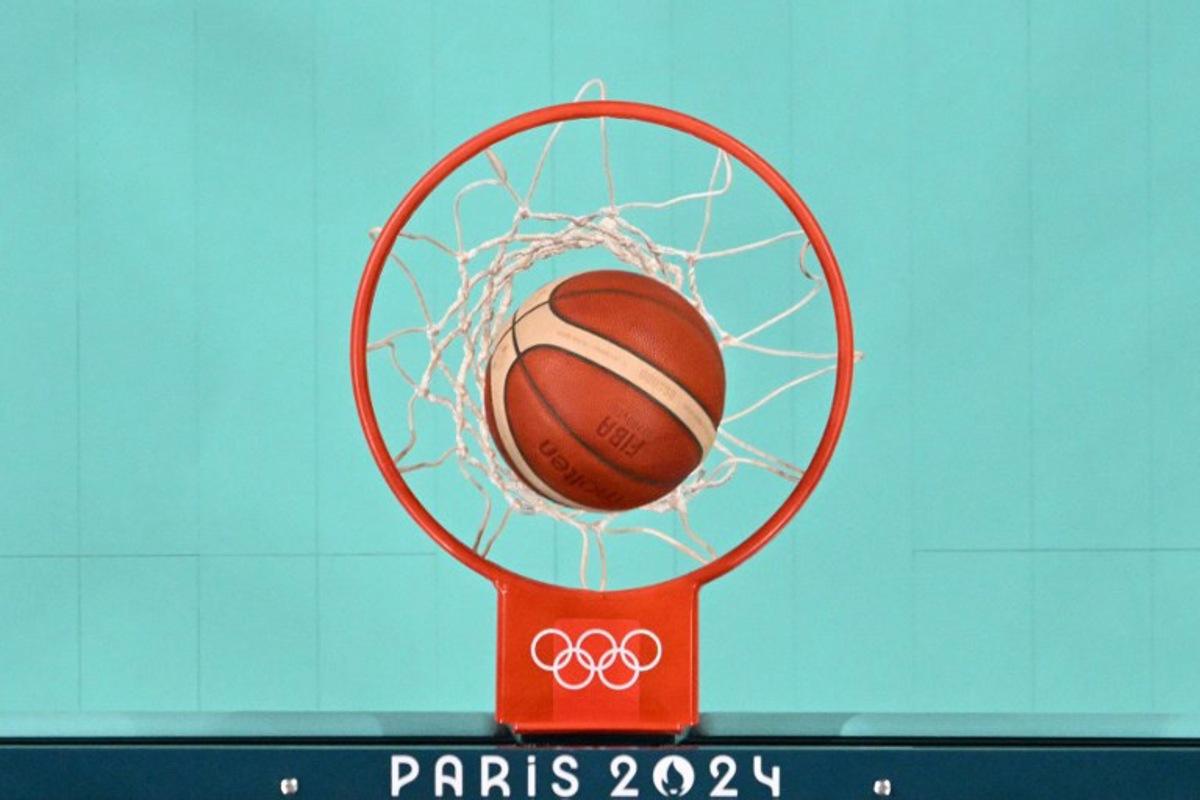 An overview shows the ball enter the basket in the women's preliminary round group A basketball match between Serbia and Puerto Rico during the Paris 2024 Olympic Games at the Pierre-Mauroy stadium in Villeneuve-d'Ascq, northern France, on July 28, 2024. Sameer Al-DOUMY / POOL / AFP