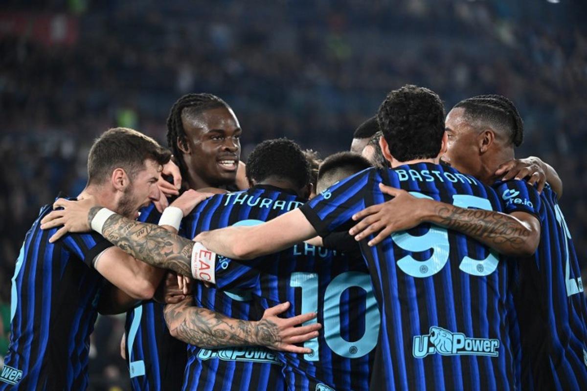 Inter players celebrate after opening the scoring during the Italian Cup (Coppa Italia) final football match between Lazio Rome and Inter Milan at the Olympic stadium in Rome on May 13, 2026. Isabella BONOTTO / AFP