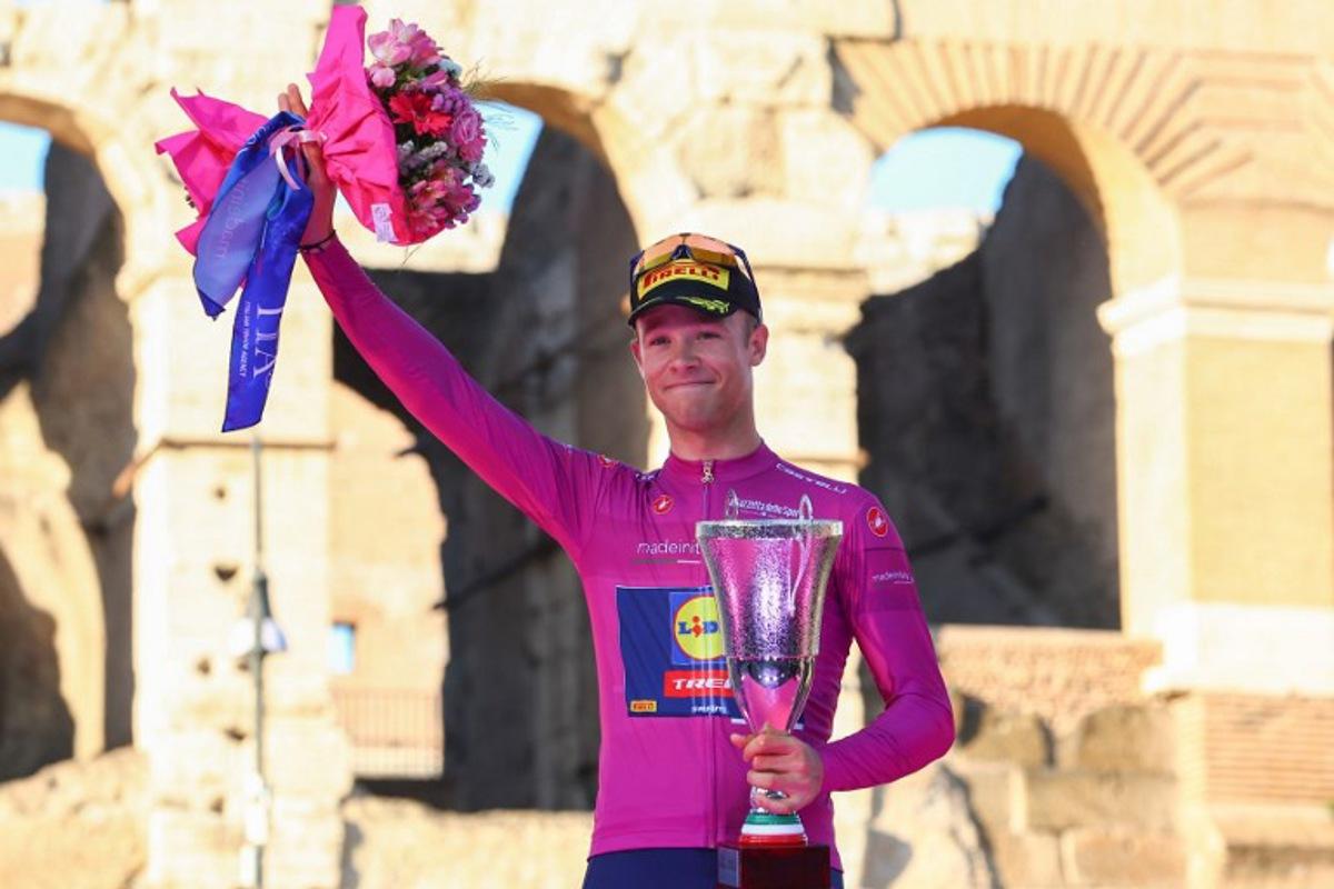 Team Lidl-Trek's Italian rider Jonathan Milan celebrates his best sprinter's purple (cyclamen) jersey on the podium in front of the Colosseum after the 21st and last stage of the 107th Giro d'Italia cycling race, 125km from Rome to Rome on May 26, 2024. Luca Bettini / AFP