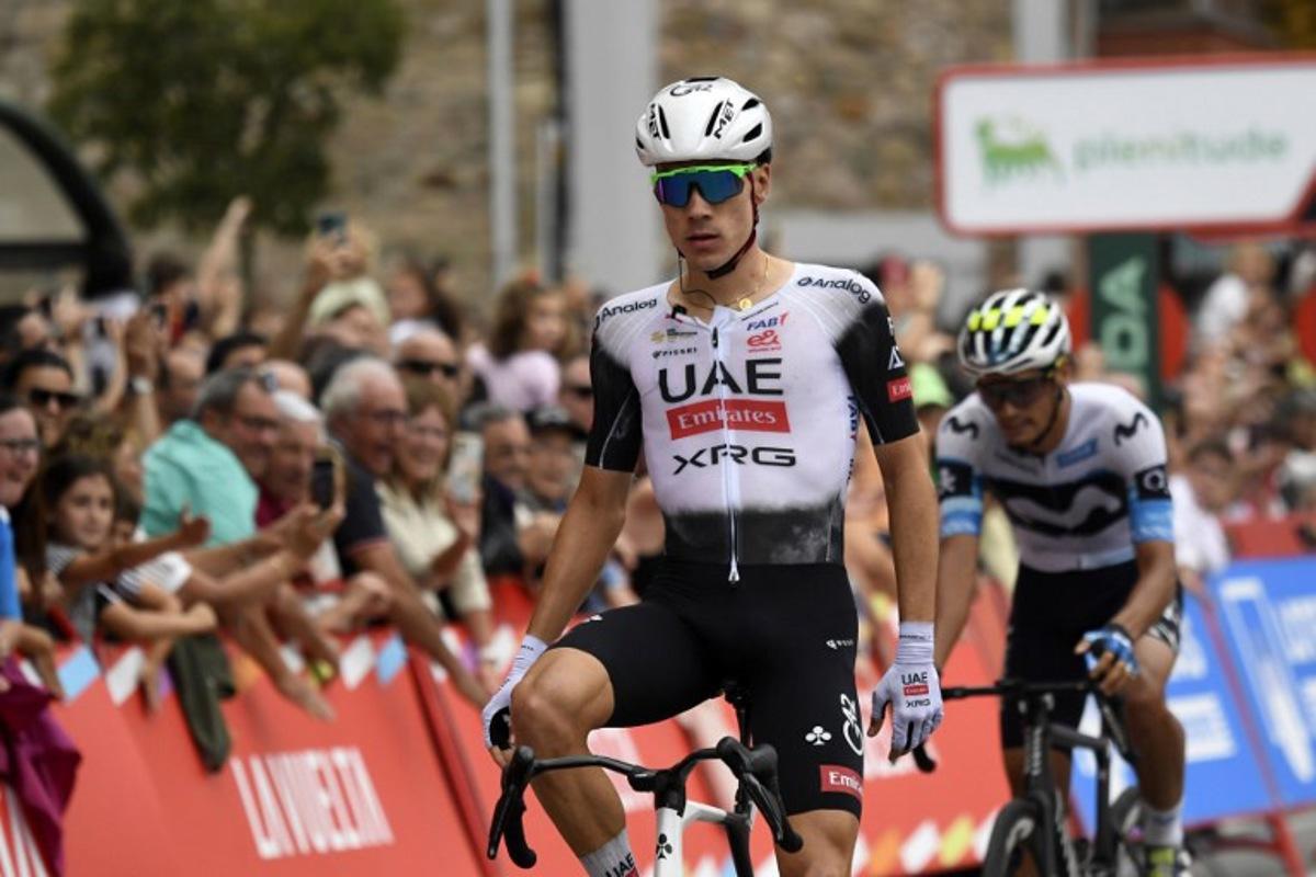 Team UAE's Spanish rider Juan Ayuso (L) crosses the finish line to win the 12th stage of the Vuelta a Espana, a 144.9 km race between Laredo and Corrales de Buelna, on September 4, 2025. ANDER GILLENEA / AFP