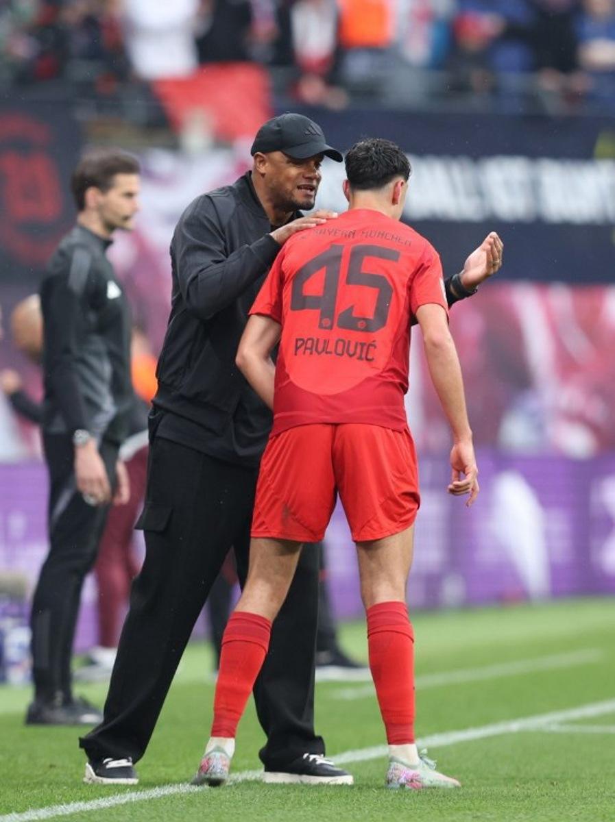 Bayern Munich's Belgian head coach Vincent Kompany (L) talks to Bayern Munich's German midfielder #45 Aleksandar Pavlovic during the German first division Bundesliga football match between RB Leipzig and FC Bayern Munich in Leipzig, eastern Germany on May 3, 2025. RONNY HARTMANN / AFP